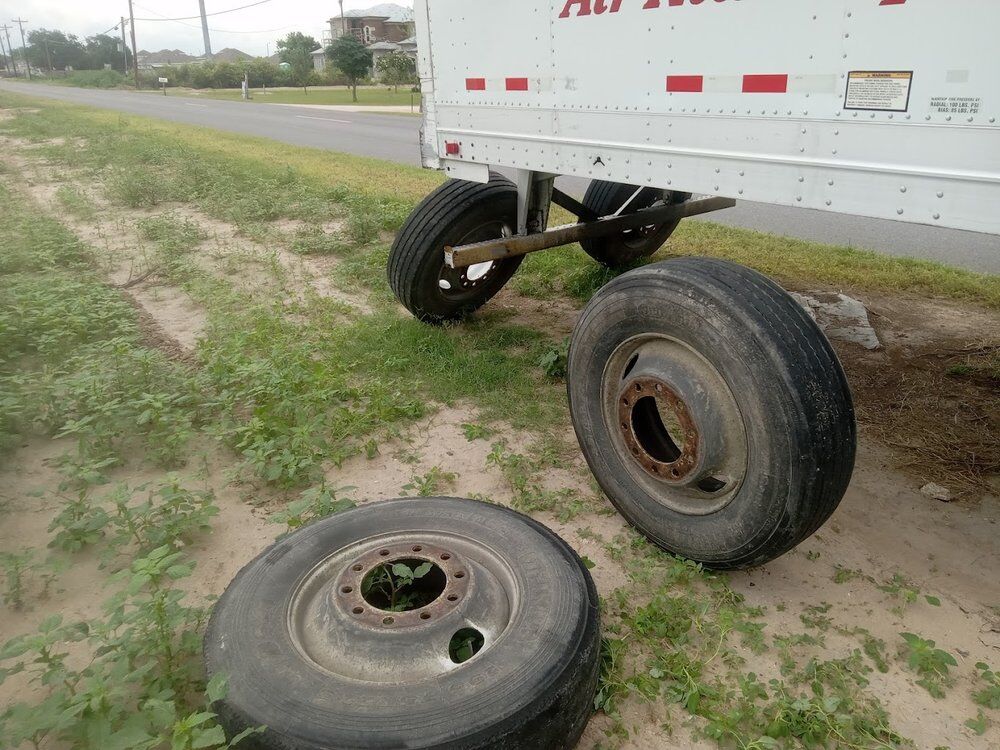 Trailer raised with wheels removed during a landing gear and axle repair