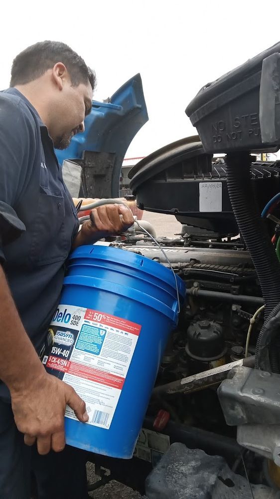 RDZ technician pouring fluid during an on-site oil and fluid service