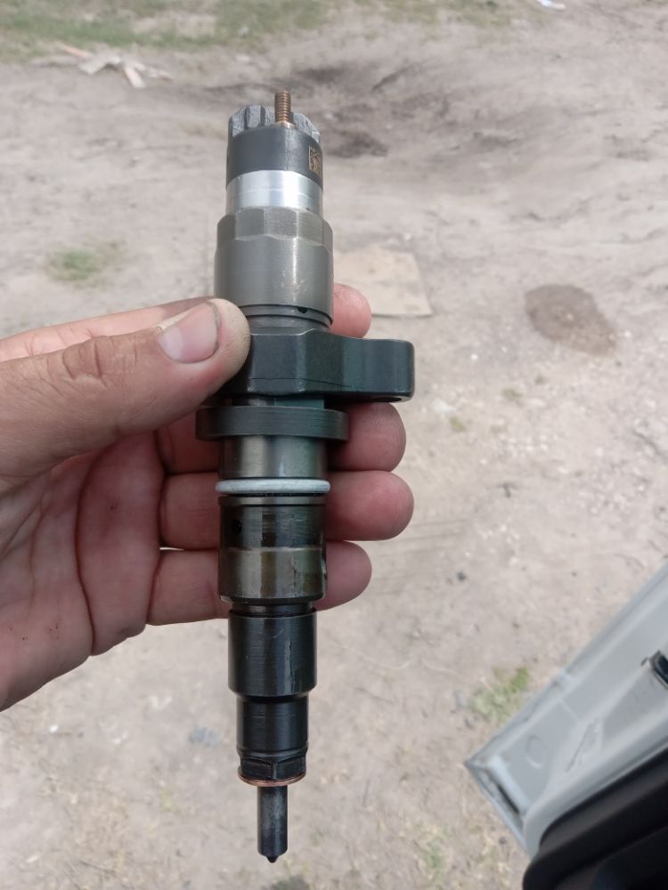 Diesel fuel injector held in hand before installation