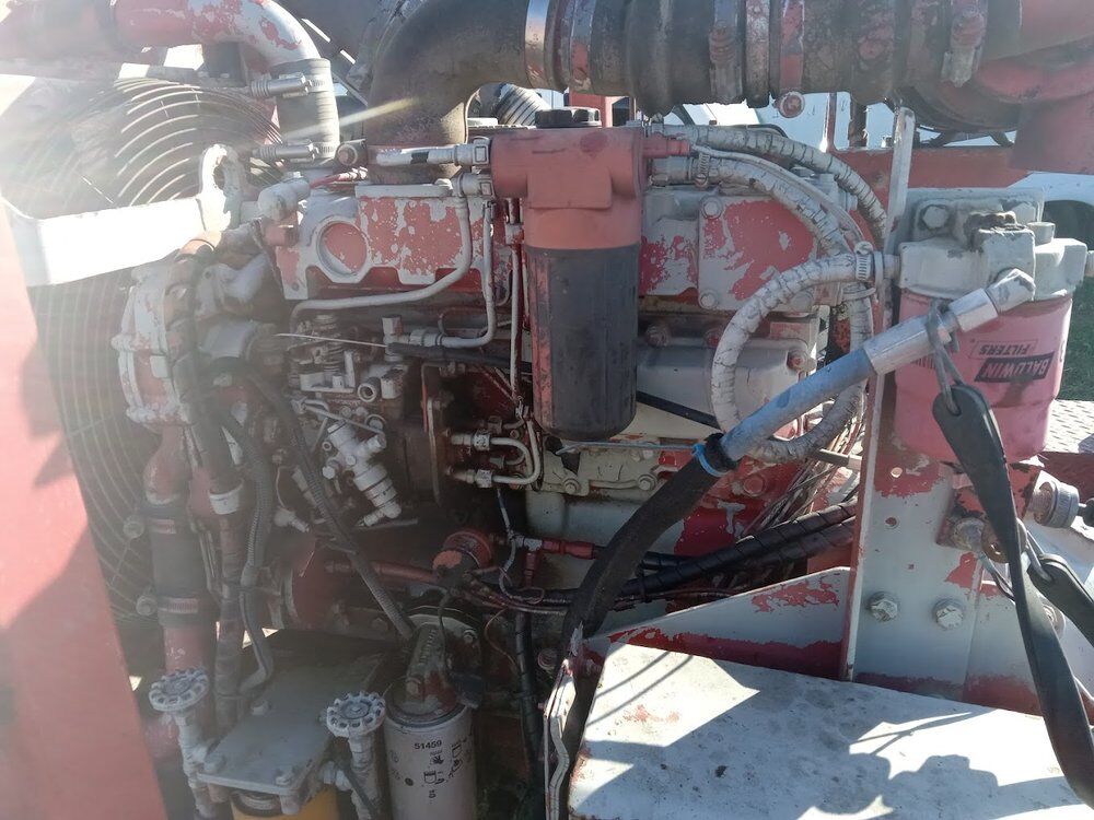 Heavy-duty engine bay opened up for repair, injector lines and fuel system visible