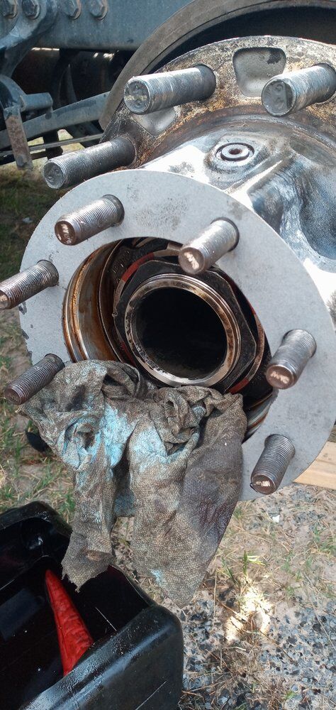 Wheel hub with damaged studs and burnt grease after a wheel end failure